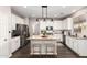Bright kitchen features granite countertops, stainless steel appliances, and a center island with bar stool seating at 5910 W Blue Sky Dr, Phoenix, AZ 85083