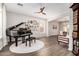 Elegant living room with a grand piano, decorative artwork, and an open floor plan at 5910 W Blue Sky Dr, Phoenix, AZ 85083