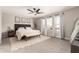 Cozy bedroom with neutral decor, carpet flooring, ceiling fan and a padded headboard at 5910 W Blue Sky Dr, Phoenix, AZ 85083