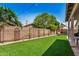 Secluded backyard featuring manicured synthetic turf, desert landscaping, and hardscape at 654 W Fremont Dr, Tempe, AZ 85282