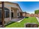 Well-maintained backyard featuring a covered patio, artificial grass and privacy wall at 654 W Fremont Dr, Tempe, AZ 85282