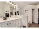 Bathroom featuring white cabinets, double sinks, built in vanity, and view of the bathtub at 654 W Fremont Dr, Tempe, AZ 85282