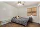 Well-lit bedroom featuring a patterned bedspread, wood-look floors, and neutral wall paint at 654 W Fremont Dr, Tempe, AZ 85282