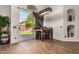 Cozy dining area features backyard view through sliding glass door, modern lighting, and stylish laminate wood flooring at 654 W Fremont Dr, Tempe, AZ 85282