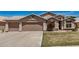 Charming single-story home featuring a low-maintenance front yard and a spacious three-car garage at 654 W Fremont Dr, Tempe, AZ 85282