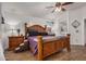 Main bedroom with wood floors, large bed, and traditional-style night stands with decorative lamps at 654 W Fremont Dr, Tempe, AZ 85282