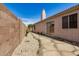Side yard with a stone walkway and desert landscaping for low maintenance living at 654 W Fremont Dr, Tempe, AZ 85282