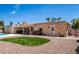 Spacious backyard with artificial turf and desert landscaping with brickwork creating a low-maintenance outdoor oasis at 6622 E Voltaire Ave, Scottsdale, AZ 85254