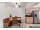 Eat-in kitchen area featuring custom bench seating, wood table, and stainless steel refrigerator at 6622 E Voltaire Ave, Scottsdale, AZ 85254