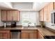 Kitchen featuring light wood cabinets, stainless steel dishwasher, and double sinks at 6622 E Voltaire Ave, Scottsdale, AZ 85254