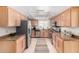 Bright kitchen featuring light wood cabinetry, stainless appliances, and a patterned runner at 6622 E Voltaire Ave, Scottsdale, AZ 85254