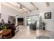 Open living room with tile flooring, ceiling fan, and sliding door to outdoor patio at 6622 E Voltaire Ave, Scottsdale, AZ 85254
