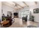 Open living room with tile flooring, ceiling fan, and sliding door to outdoor patio at 6622 E Voltaire Ave, Scottsdale, AZ 85254