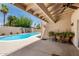 Outdoor patio area offers a shady spot to relax near the beautiful pool in the backyard at 6622 E Voltaire Ave, Scottsdale, AZ 85254