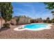 Charming pool with diving board surrounded by desert landscaping, offering a relaxing and private outdoor retreat at 6622 E Voltaire Ave, Scottsdale, AZ 85254
