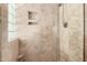 Tiled shower with glass door and built-in niche at 6622 E Voltaire Ave, Scottsdale, AZ 85254