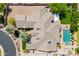 Aerial view of home with a backyard oasis featuring a pool, spa, outdoor kitchen, and mature landscaping at 7018 E Ingram St, Mesa, AZ 85207