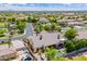 Aerial view of home with a backyard oasis featuring a pool, spa, outdoor kitchen, and mature landscaping at 7018 E Ingram St, Mesa, AZ 85207