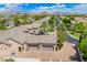 Aerial view of a home showcasing a three car garage, landscaping, and mountain views on a sunny day at 7018 E Ingram St, Mesa, AZ 85207