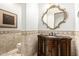 Powder bathroom featuring decorative sink, stylish tile, and attractive framed mirror at 7018 E Ingram St, Mesa, AZ 85207