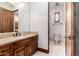 Elegant bathroom featuring a granite countertop, decorative mirror, and separate toilet area at 7018 E Ingram St, Mesa, AZ 85207