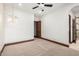 Bedroom with neutral carpet, designer lighting, a ceiling fan, and access to an en-suite bathroom at 7018 E Ingram St, Mesa, AZ 85207