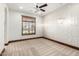 Bedroom features designer wallpaper, ceiling fan, and window with wood shutters offering comfortable living space at 7018 E Ingram St, Mesa, AZ 85207