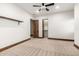 Bedroom showcasing an adjacent walk-in closet, carpet floors, and a wooden door at 7018 E Ingram St, Mesa, AZ 85207
