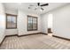 Bedroom featuring window shutters, carpet floors, a ceiling fan, and an attached bath area at 7018 E Ingram St, Mesa, AZ 85207