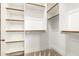 An organized walk-in closet offers white shelves and chrome rods for optimal closet storage at 7018 E Ingram St, Mesa, AZ 85207