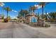Elegant gated community entrance with lush landscaping and brick-paved road at 7018 E Ingram St, Mesa, AZ 85207