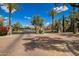 Elegant gated community entrance with lush landscaping and brick-paved road at 7018 E Ingram St, Mesa, AZ 85207