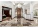 Elegant entryway boasting a stone tile floor, soaring ceilings, and a beautiful wood door at 7018 E Ingram St, Mesa, AZ 85207