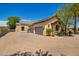 This property features a spacious three-car garage and an adjacent stone accented entrance at 7018 E Ingram St, Mesa, AZ 85207