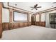 Spacious home theater room with wood trim, carpet, and screen at 7018 E Ingram St, Mesa, AZ 85207