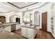 Spacious kitchen with stainless steel appliances, large center island, and custom cabinets at 7018 E Ingram St, Mesa, AZ 85207