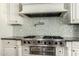 Close-up of Viking stainless steel cooktop with pot filler faucet and decorative tile backsplash at 7018 E Ingram St, Mesa, AZ 85207