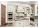 Detailed kitchen with stainless steel appliances, large center island, and custom cabinetry at 7018 E Ingram St, Mesa, AZ 85207