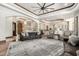 Open-concept living room with hardwood floors, neutral furniture, and views into the kitchen at 7018 E Ingram St, Mesa, AZ 85207