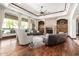 Bright living room with hardwood floors, a stone fireplace, elegant furniture, and a ceiling fan at 7018 E Ingram St, Mesa, AZ 85207