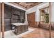 Home office with custom built-in shelving, hardwood floors, and a desk with a stone countertop at 7018 E Ingram St, Mesa, AZ 85207