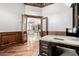 Home office with hardwood flooring, wood trim, and see-through glass doors at 7018 E Ingram St, Mesa, AZ 85207