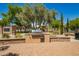 Outdoor kitchen with a built-in grill, brick pavers, and landscaping creating a functional outdoor space at 7018 E Ingram St, Mesa, AZ 85207