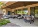 Enjoy the outdoor living space, complete with comfortable seating, a dining table, and ceiling fans at 7018 E Ingram St, Mesa, AZ 85207