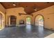 Covered outdoor living space featuring a fireplace, brick accents, and access to the outdoor pool at 7018 E Ingram St, Mesa, AZ 85207