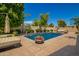 Beautiful pool with a flower pot in the center with manicured landscaping at 7018 E Ingram St, Mesa, AZ 85207