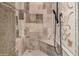 This bathroom features a walk in shower with stone tile and built in niche at 7018 E Ingram St, Mesa, AZ 85207