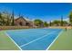 Community tennis court with a clubhouse, basketball hoops, and well-maintained green surroundings at 7018 E Ingram St, Mesa, AZ 85207