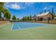 Community tennis court with a clubhouse, basketball hoops, and well-maintained green surroundings at 7018 E Ingram St, Mesa, AZ 85207