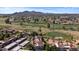 Breathtaking aerial view of community, lush golf course, and picturesque mountain backdrop at 7405 N Via Camello Del Norte -- # 137, Scottsdale, AZ 85258